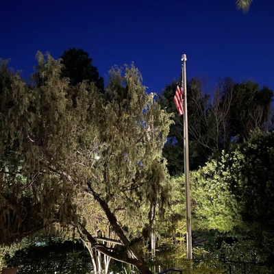 Landscape and pathway lighting near this flag pole adds security and safety after dark. Photo